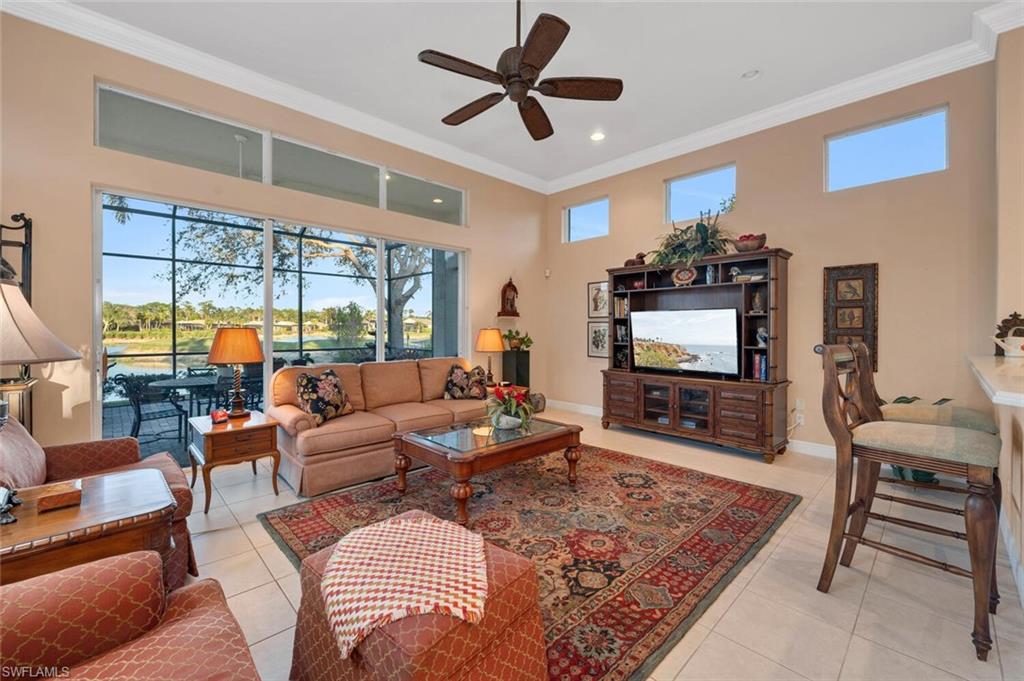 5044 Castlerock Way Naples, FL 34112 - Photo 6 of 38 a living room with furniture and a flat screen tv