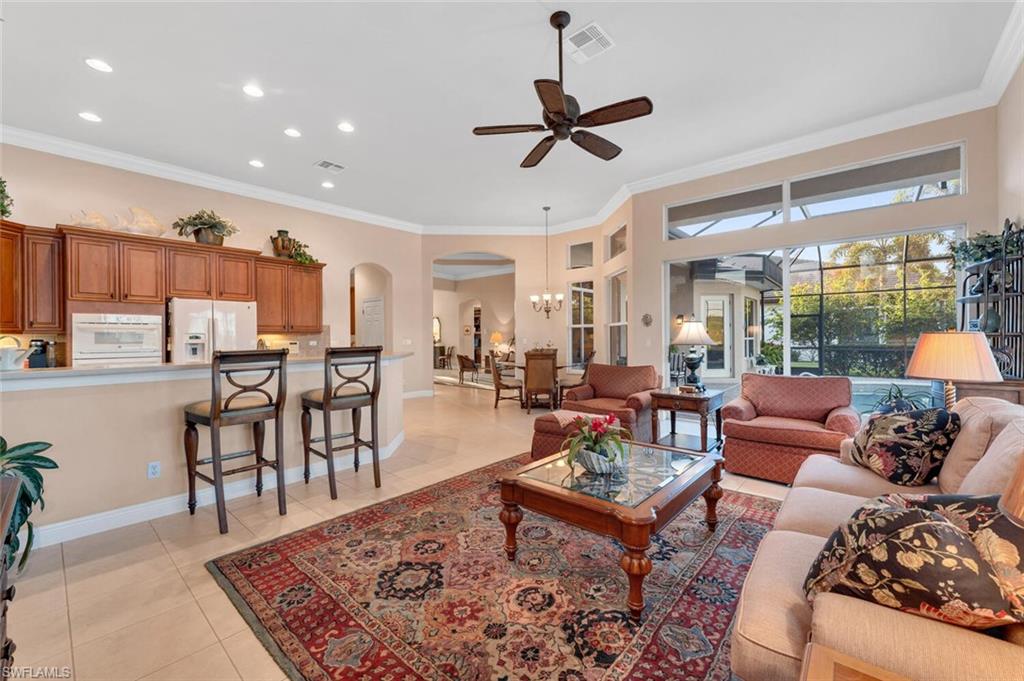 5044 Castlerock Way Naples, FL 34112 - Photo 7 of 38 a living room with furniture and a wooden floor