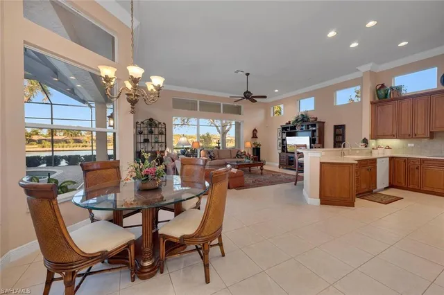 a dining room with kitchen island furniture a chandelier and kitchen view