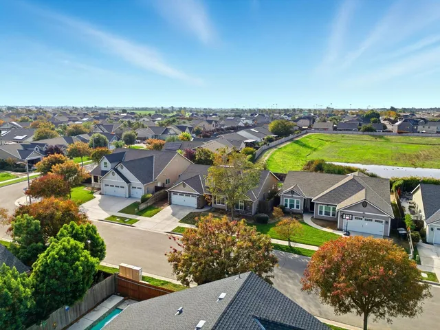 an aerial view of residential houses with outdoor space