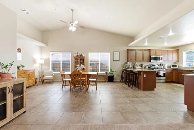 a dining room with furniture and large windows