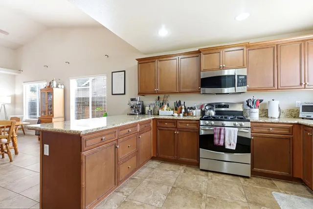 a kitchen with stainless steel appliances granite countertop a refrigerator and a sink