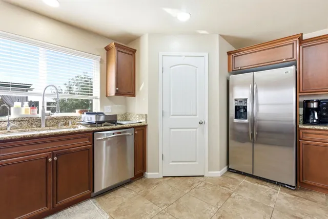 a large kitchen with cabinets and stainless steel appliances