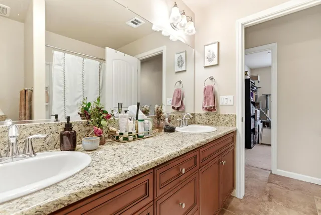 a bed sitting in a bedroom next to a book shelf
