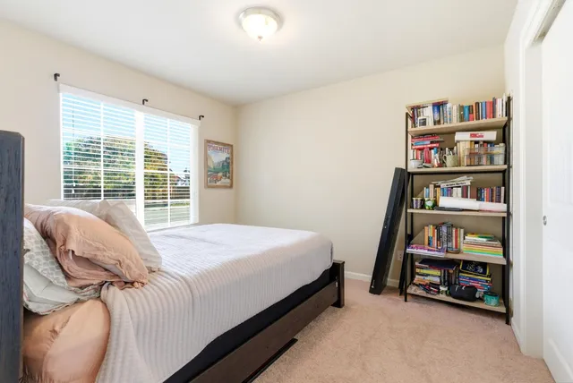 a bedroom with a bed and a painting