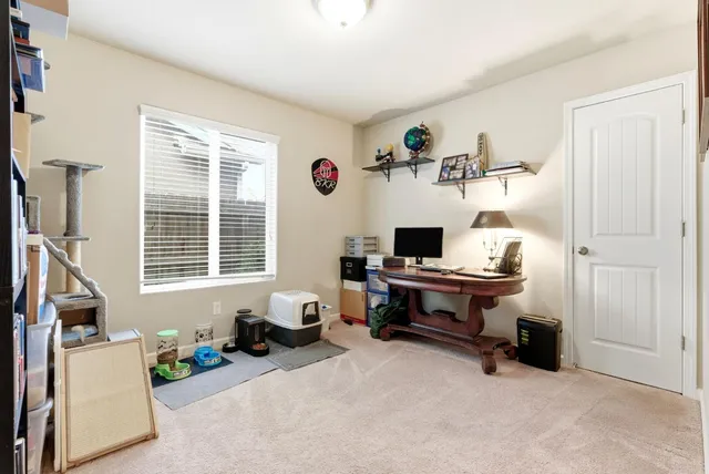a bedroom with a bed dresser and window