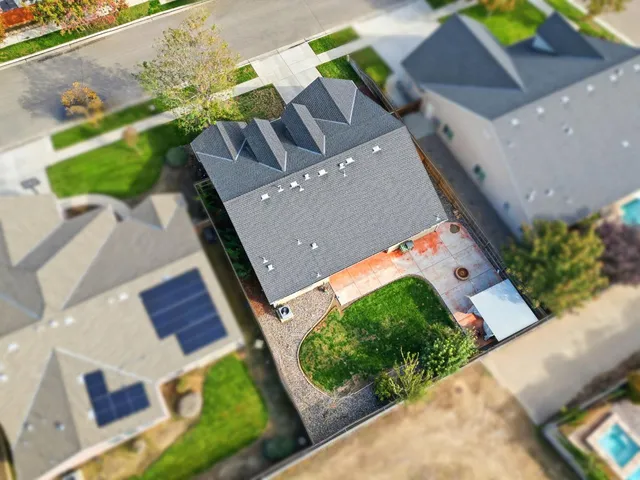 an aerial view of residential houses with outdoor space