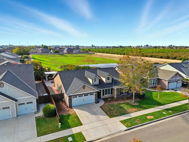 a view of a house with pool and chairs