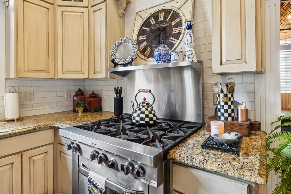 3631 Louisville Road Louisville, TN 37777 - Photo 17 of 64 a kitchen with granite countertop a stove and a white wooden cabinets