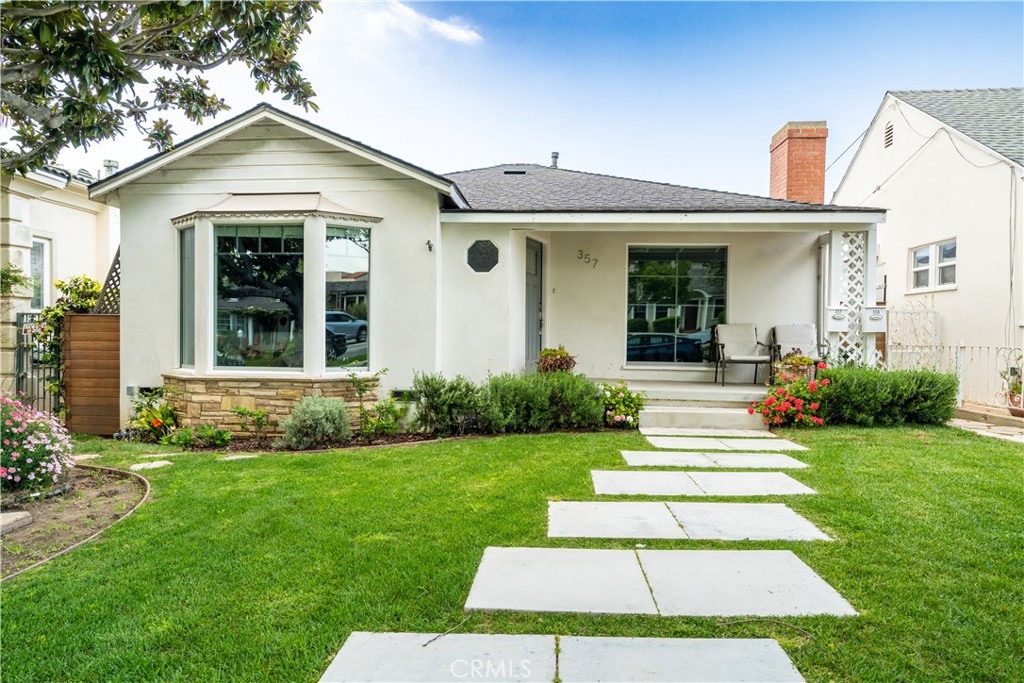 357 Whiting Street El Segundo, CA 90245 - Photo 2 of 50 a front view of a house with a yard
