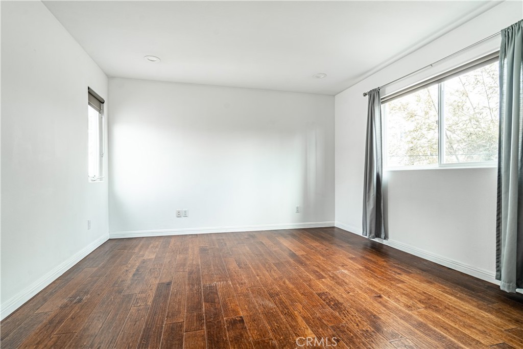 357 Whiting Street El Segundo, CA 90245 - Photo 43 of 50 an empty room with wooden floor and windows