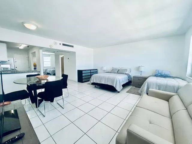 a living room with furniture and a mirror