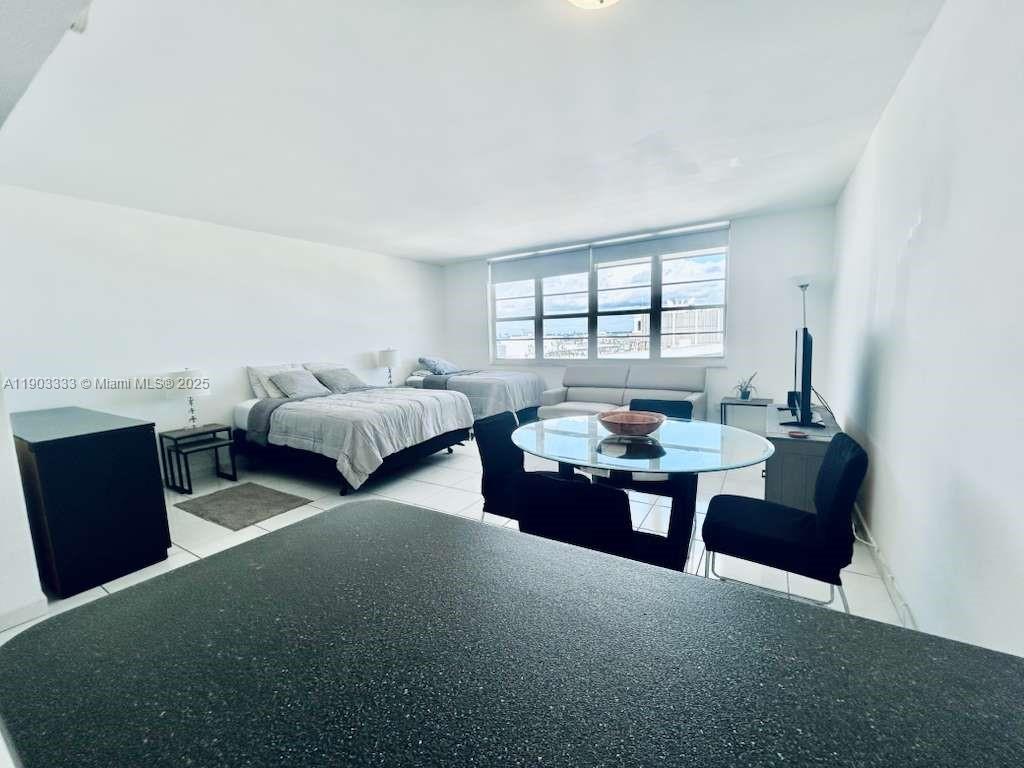 100 Lincoln Road, Unit 1639 Miami Beach, FL 33139 - Photo 4 of 10 a living room with furniture and a large window