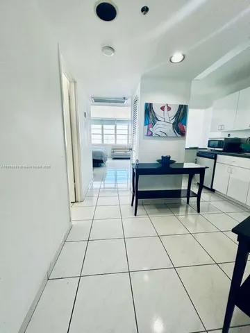 a view of a hallway with seating area and appliances