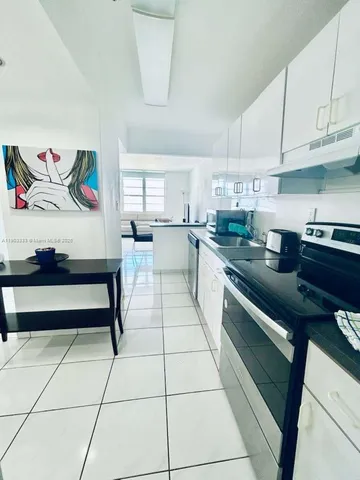 a kitchen with stainless steel appliances cabinets a sink and a counter top space