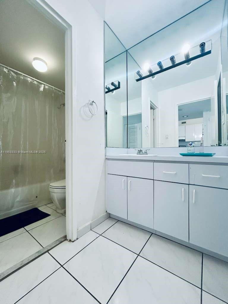100 Lincoln Road, Unit 1639 Miami Beach, FL 33139 - Photo 8 of 10 a bathroom with a double vanity sink toilet and shower