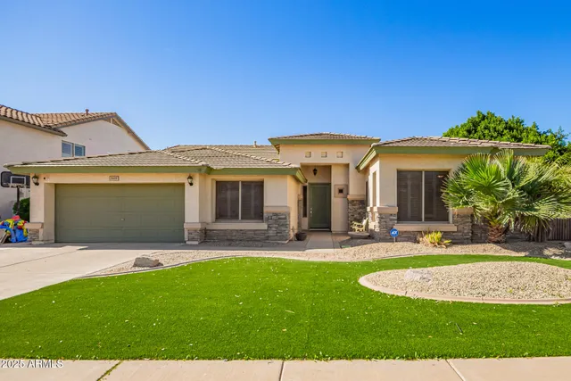a view of a house with a yard and sitting area