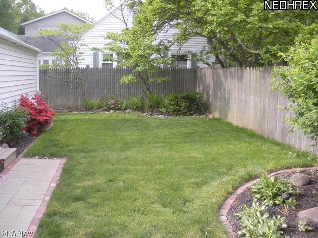 1144 Garman Road Akron, OH 44313 - Photo 20 of 22 Beautifully landscaped backyard with mature plants and trees.