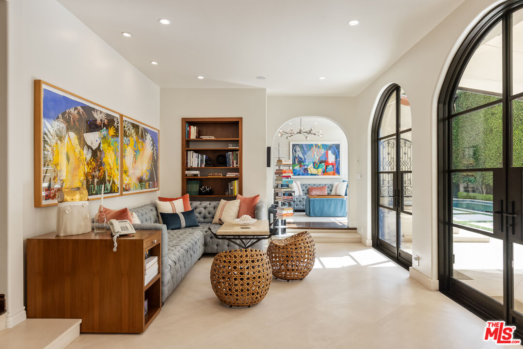 1109 Tower Road Beverly Hills, CA 90210 - Photo 11 of 32 a living room with furniture and a floor to ceiling window