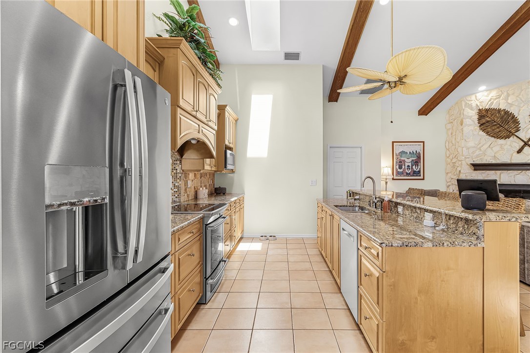 7747 Grande Pine Road Bokeelia, FL 33922 - Photo 11 of 45 a kitchen with stainless steel appliances granite countertop a refrigerator and a stove