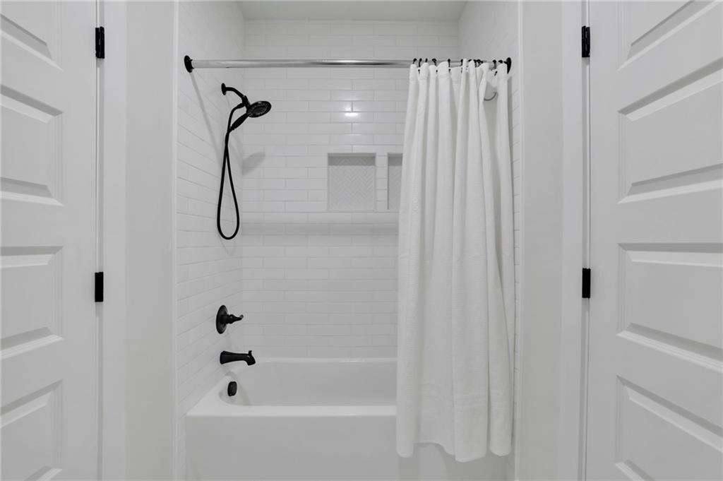 1610 Double Springs Church Road Monroe, GA 30656 - Photo 15 of 81 a bathroom with a shower and a bath tub