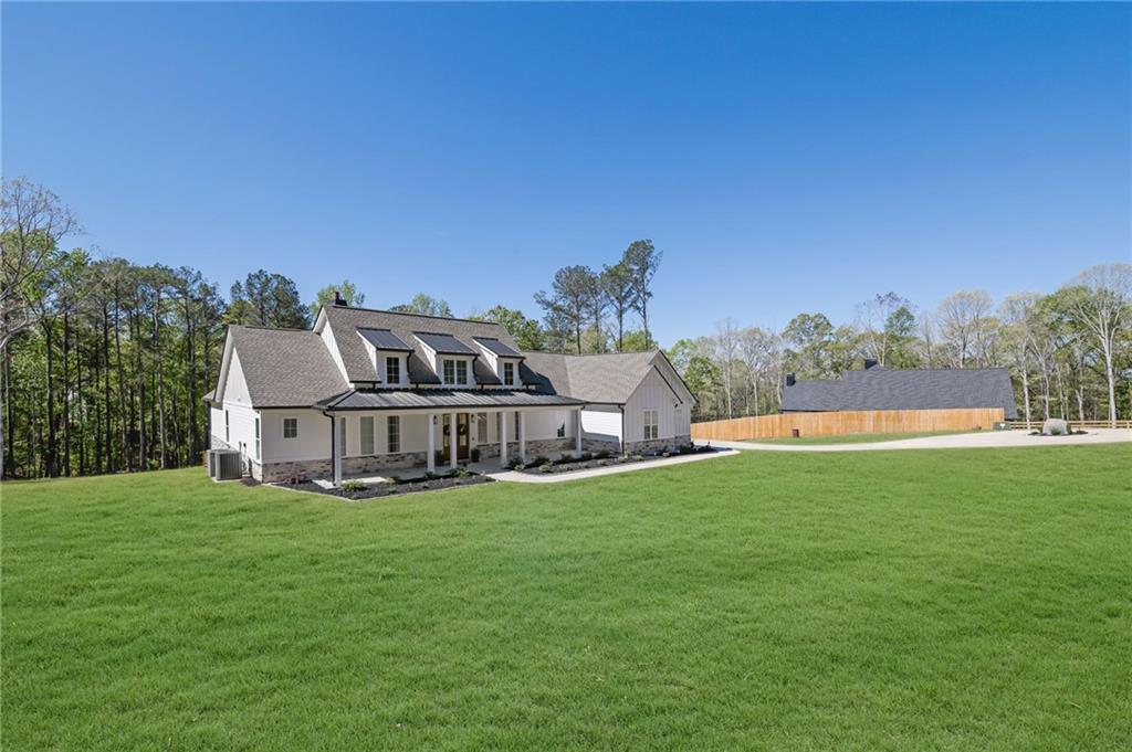 1610 Double Springs Church Road Monroe, GA 30656 - Photo 4 of 81 a view of a house with a big yard and potted plants