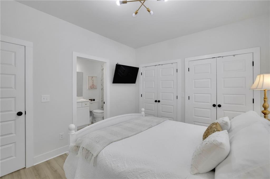 1610 Double Springs Church Road Monroe, GA 30656 - Photo 10 of 81 a bedroom with a bed and a flat tv screen on the dresser