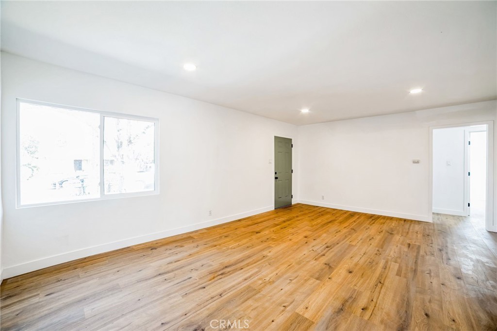 2746 Prospect Avenue Riverside, CA 92507 - Photo 3 of 10 a view of an empty room with wooden floor and a window