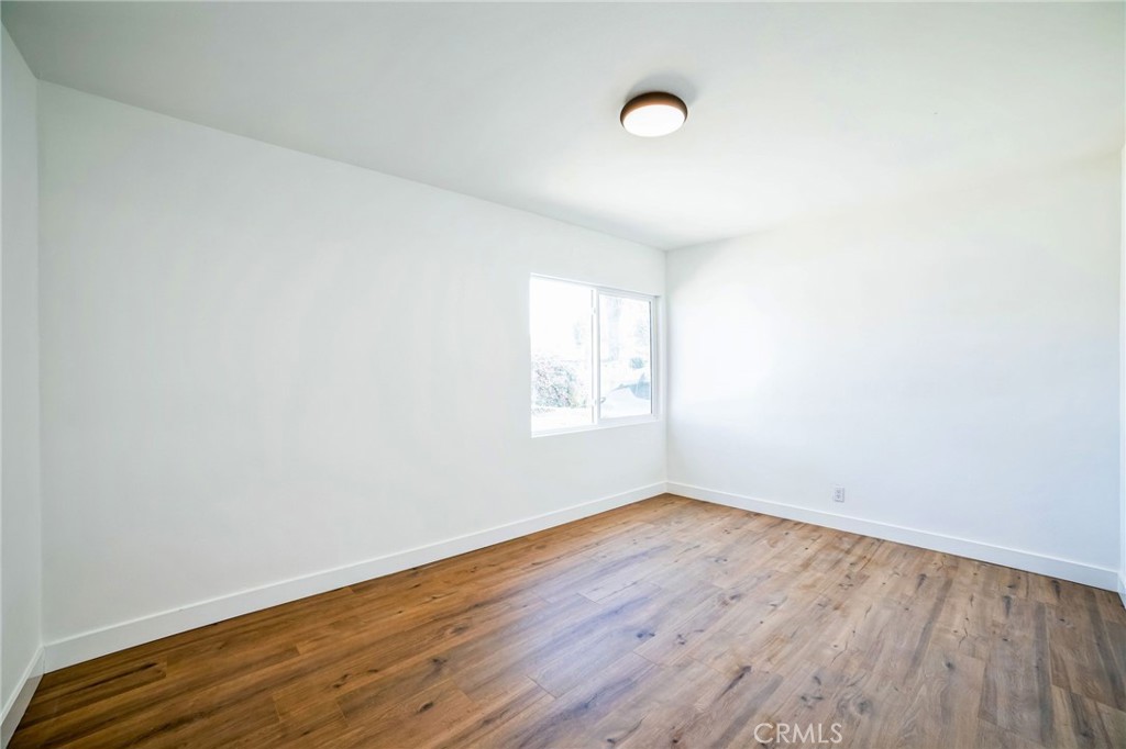 2746 Prospect Avenue Riverside, CA 92507 - Photo 7 of 10 an empty room with wooden floor and windows