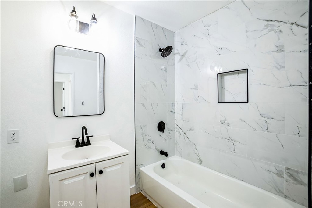 2746 Prospect Avenue Riverside, CA 92507 - Photo 8 of 10 a bathroom with a sink mirror and a bathtub