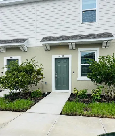 a front view of the house with garden