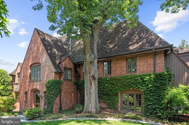 front view of a house with a yard and potted plants