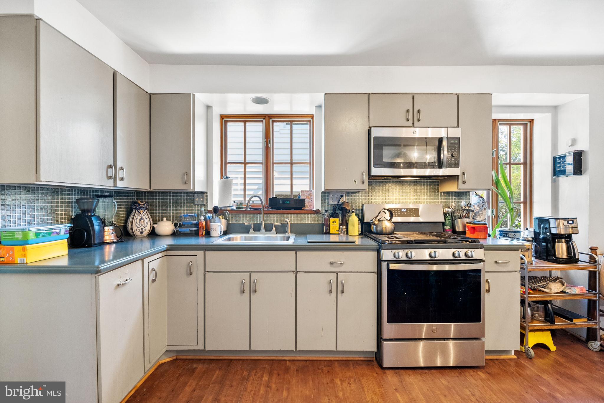 3111 Idaho Avenue Northwest Washington, DC 20016 - Photo 22 of 40 a kitchen with stainless steel appliances a stove a sink and a microwave