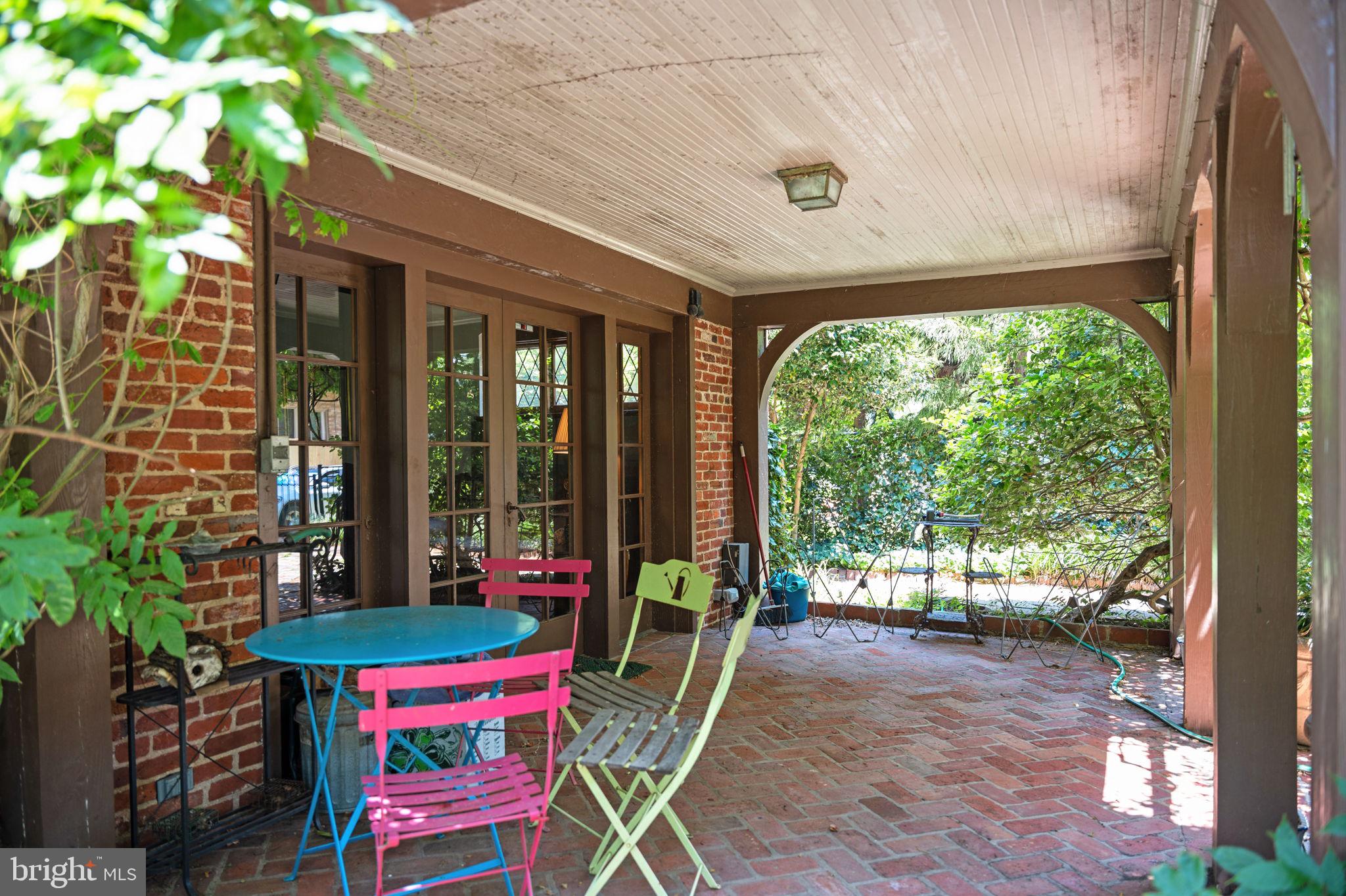 3111 Idaho Avenue Northwest Washington, DC 20016 - Photo 36 of 40 a view of a patio with a table and chairs next to a yard