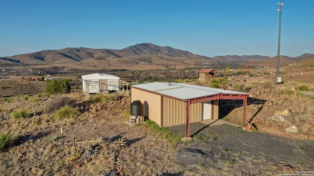 a view of a house with a mountain and a forest