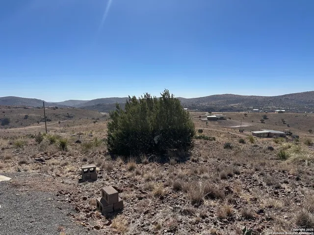 a view of a large mountain with mountains in the background
