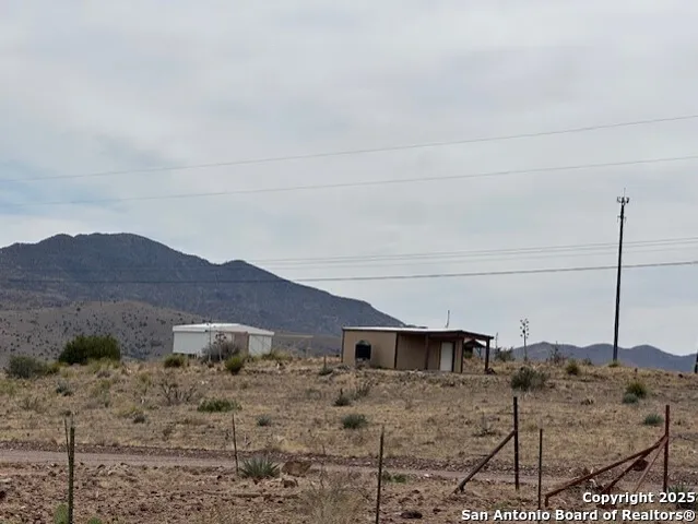 a view of a house with a yard and a mountain