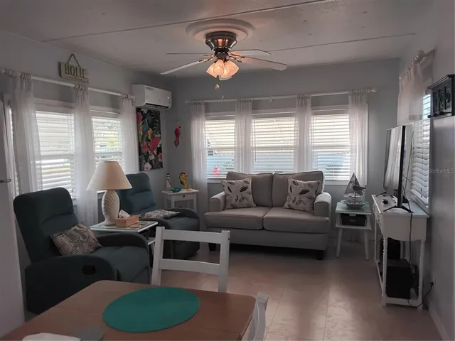 a living room with furniture fireplace and a large window