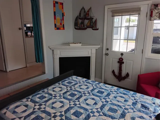 a bedroom with a bed and a lamp