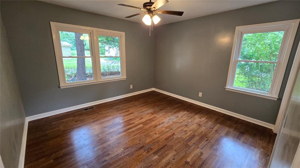 700 New Street Eatonton, GA 31024 - Photo 12 of 19 a view of empty room with wooden floor and fan
