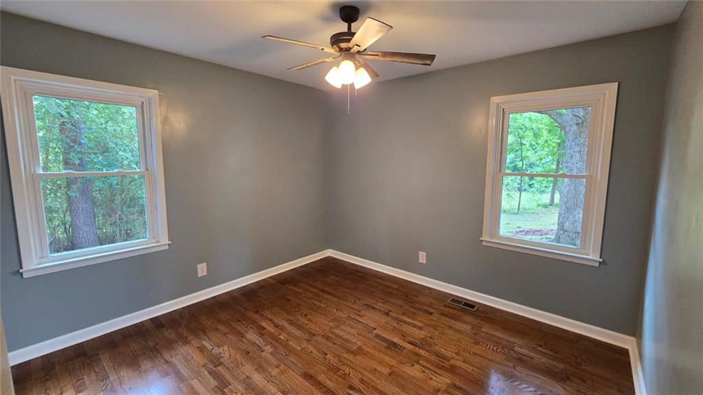 700 New Street Eatonton, GA 31024 - Photo 15 of 19 a view of an empty room with wooden floor and a window