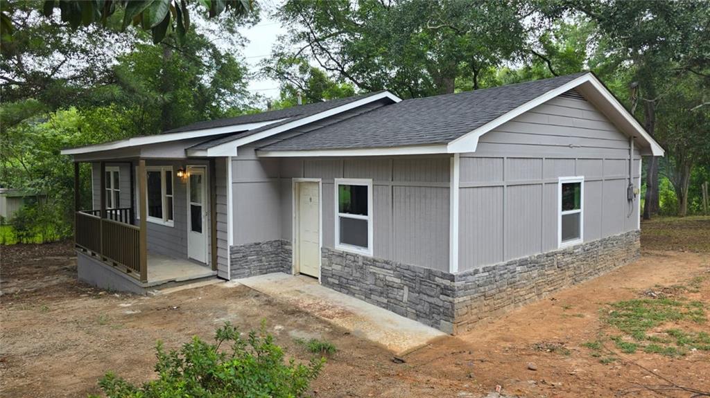 700 New Street Eatonton, GA 31024 - Photo 2 of 19 a view of a yard in front of a house with large windows