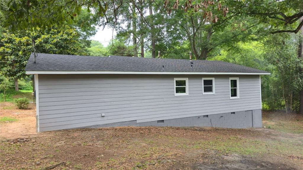 700 New Street Eatonton, GA 31024 - Photo 3 of 19 a view of a house with a backyard