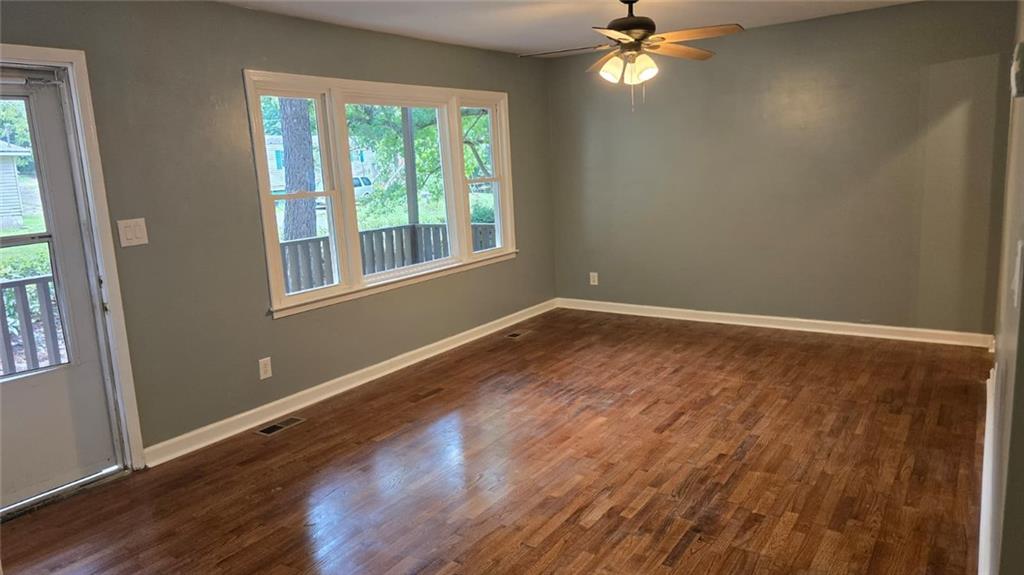 700 New Street Eatonton, GA 31024 - Photo 5 of 19 a view of empty room with wooden floor and fan