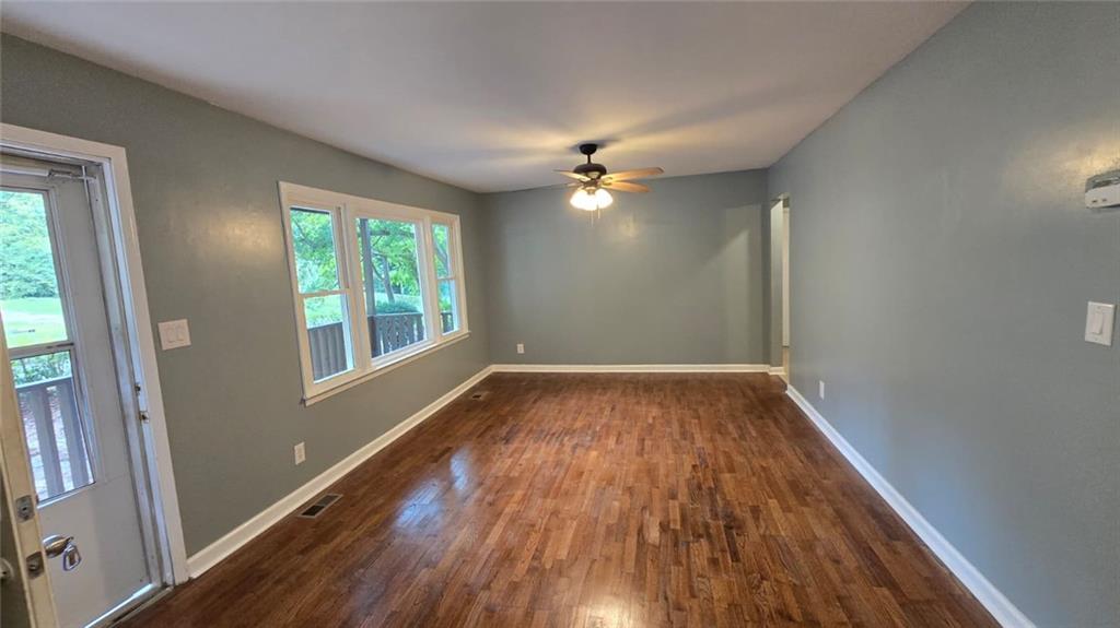 700 New Street Eatonton, GA 31024 - Photo 6 of 19 wooden floor in an empty room with a window