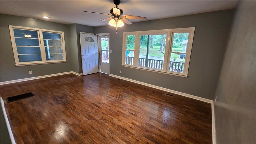 700 New Street Eatonton, GA 31024 - Photo 7 of 19 a view of an empty room with a window and wooden floor