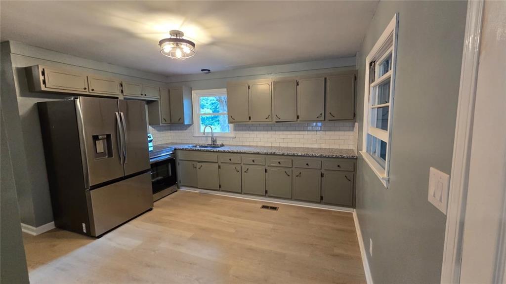 700 New Street Eatonton, GA 31024 - Photo 8 of 19 a kitchen with stainless steel appliances a refrigerator and a stove