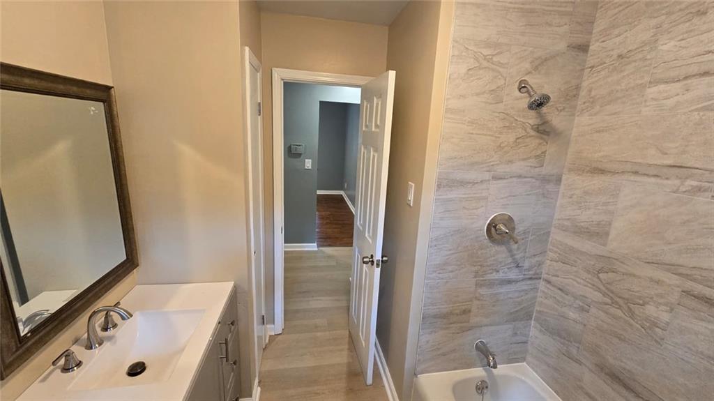 700 New Street Eatonton, GA 31024 - Photo 10 of 19 a bathroom with a tub sink and mirror