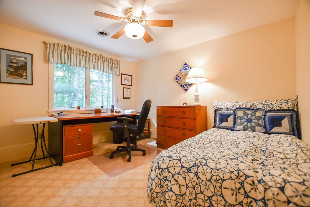 37 Register Road Marion, MA 02738 - Photo 31 of 42 a bedroom with a bed and a chandelier