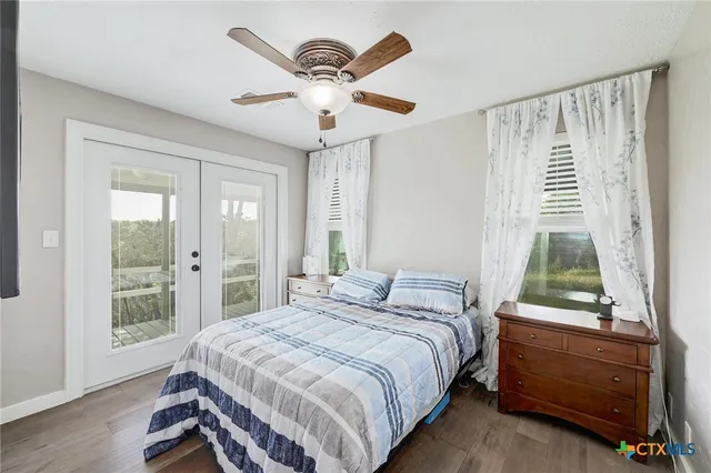 a spacious bedroom with a bed and a flat screen tv